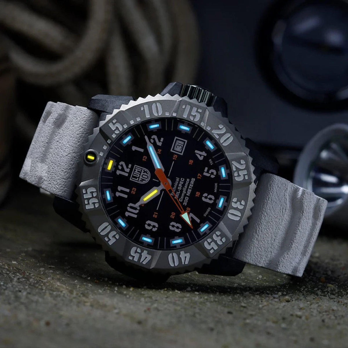 Luminox MIL-SPEC 46mm watch with black dial, orange hands, and blue luminous markers