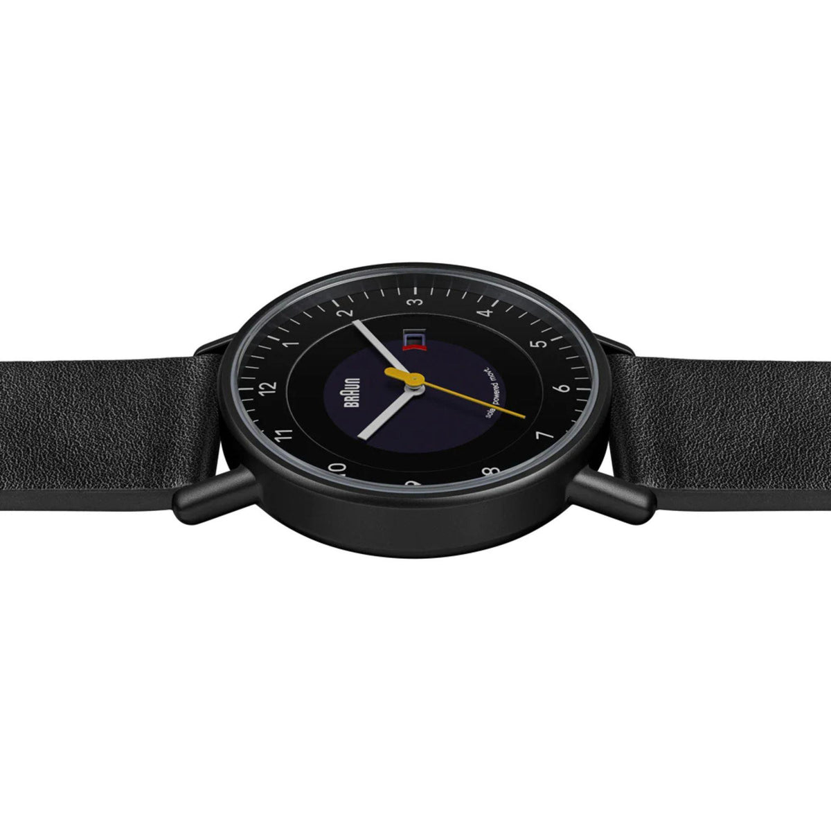 Men's solar powered watch close-up, black dial with date window and yellow seconds hand