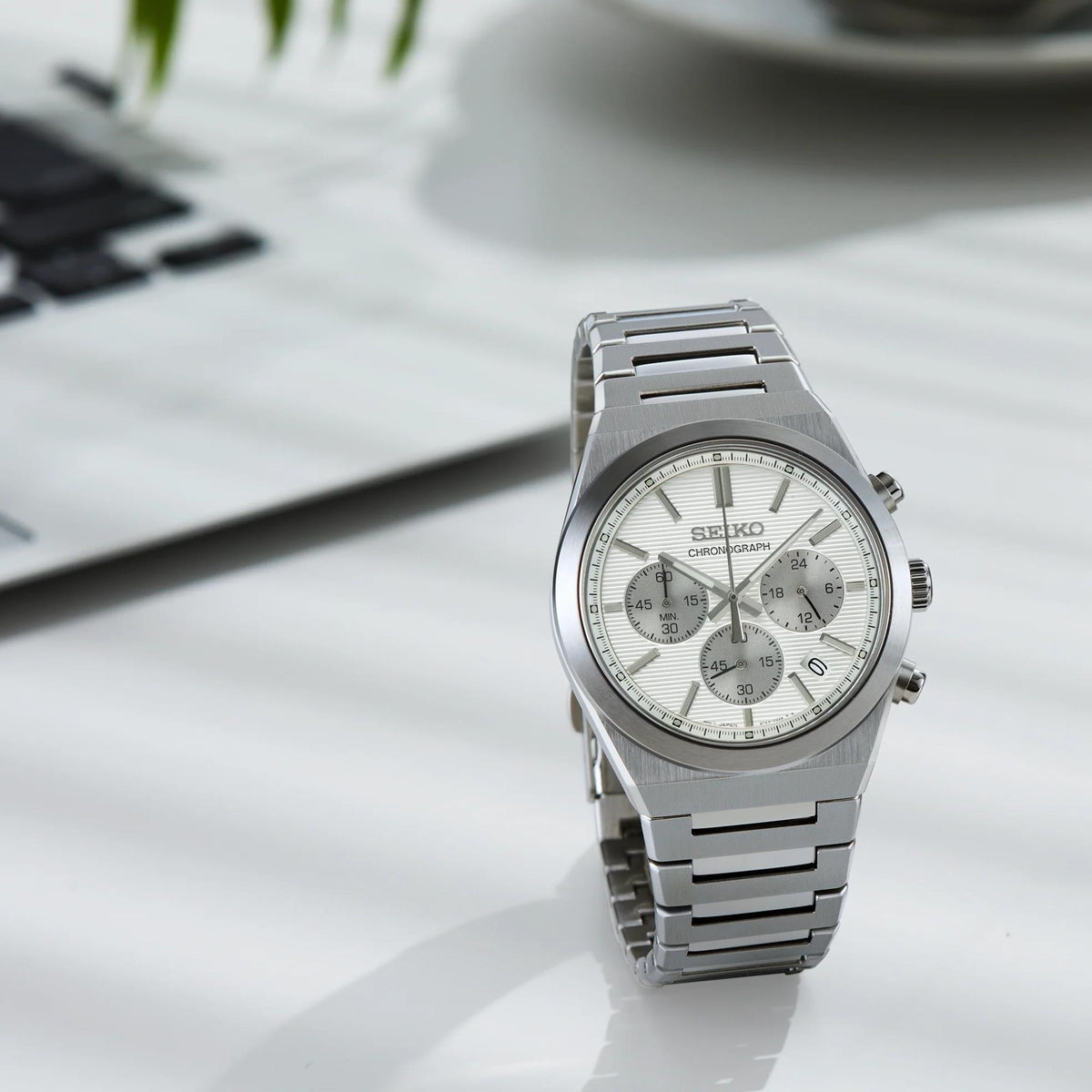Seiko Essentials SSB451P1 angled desk view displaying silver dial chronograph feature and brushed steel bracelet