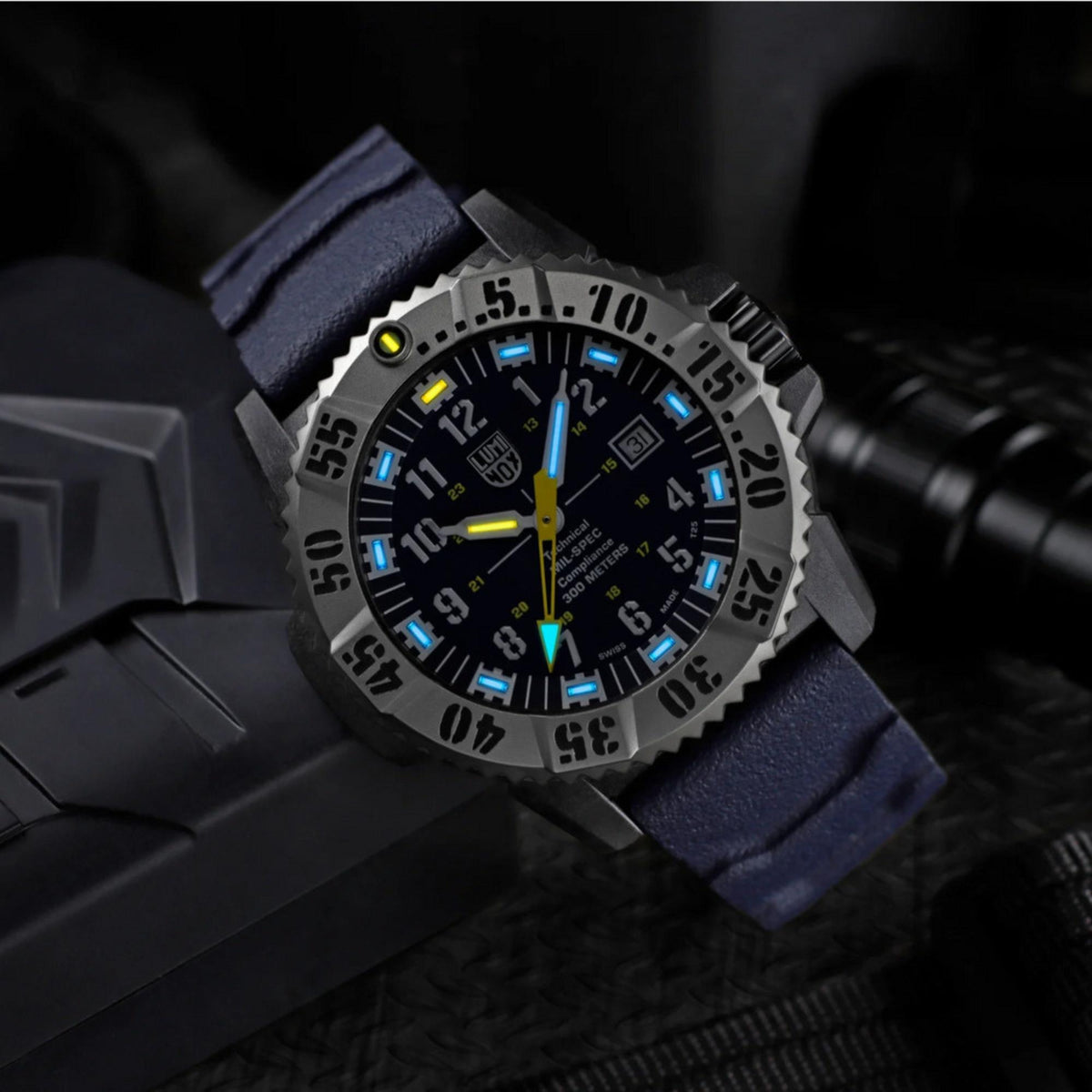 MIL-SPEC rubber watch with blue dial, glowing markers, and dark blue strap