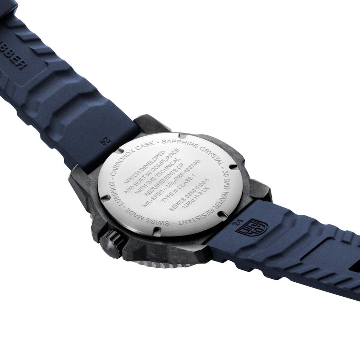 Back of MIL-SPEC rubber watch case with engraved text and dark blue strap