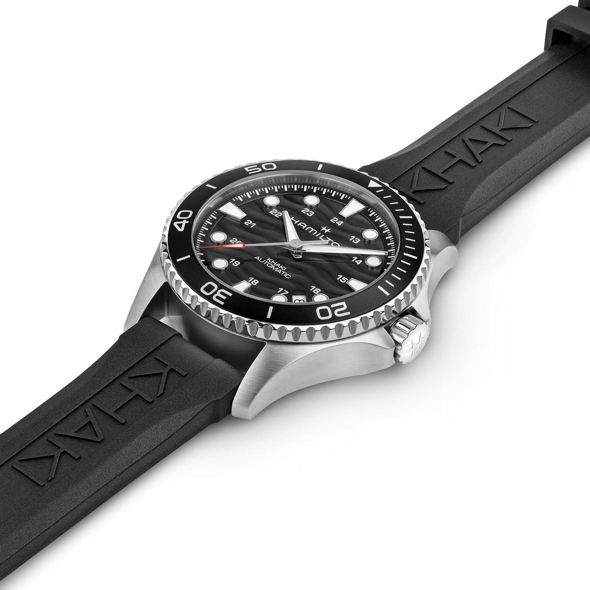 Hamilton Khaki Navy Scuba H82415330 automatic watch flat lay perspective displaying black dial, stainless steel case, and textured black rubber strap