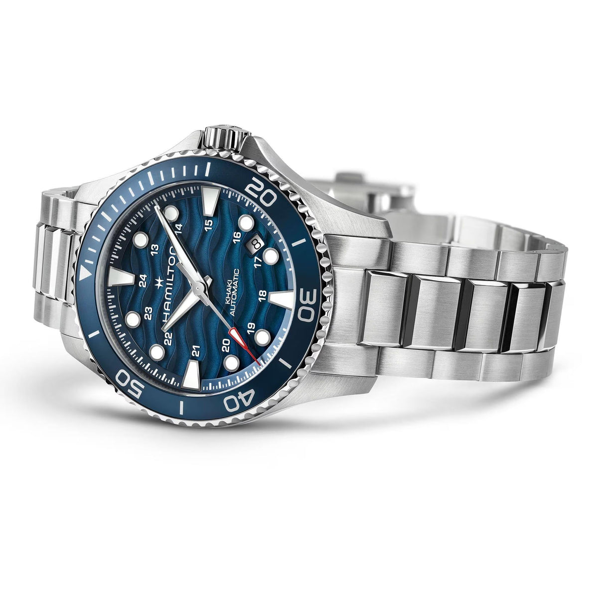 Stainless steel dive watch with blue dial and rotating bezel, three-quarter view on wrist