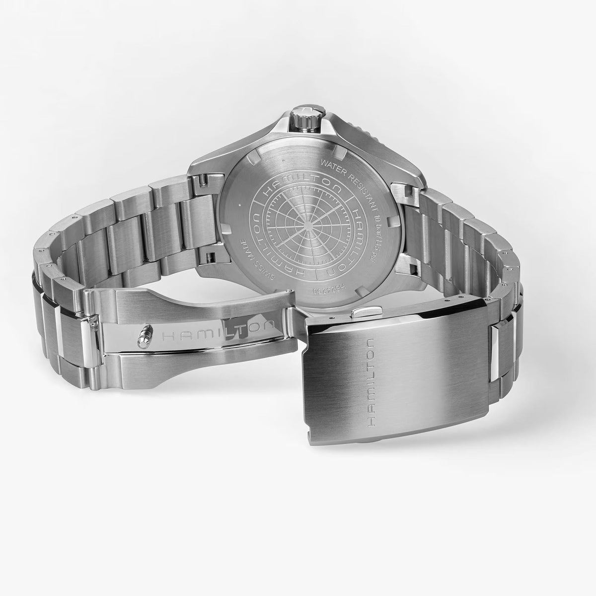 Stainless steel watch case back with engraved markings and link bracelet, dial side away