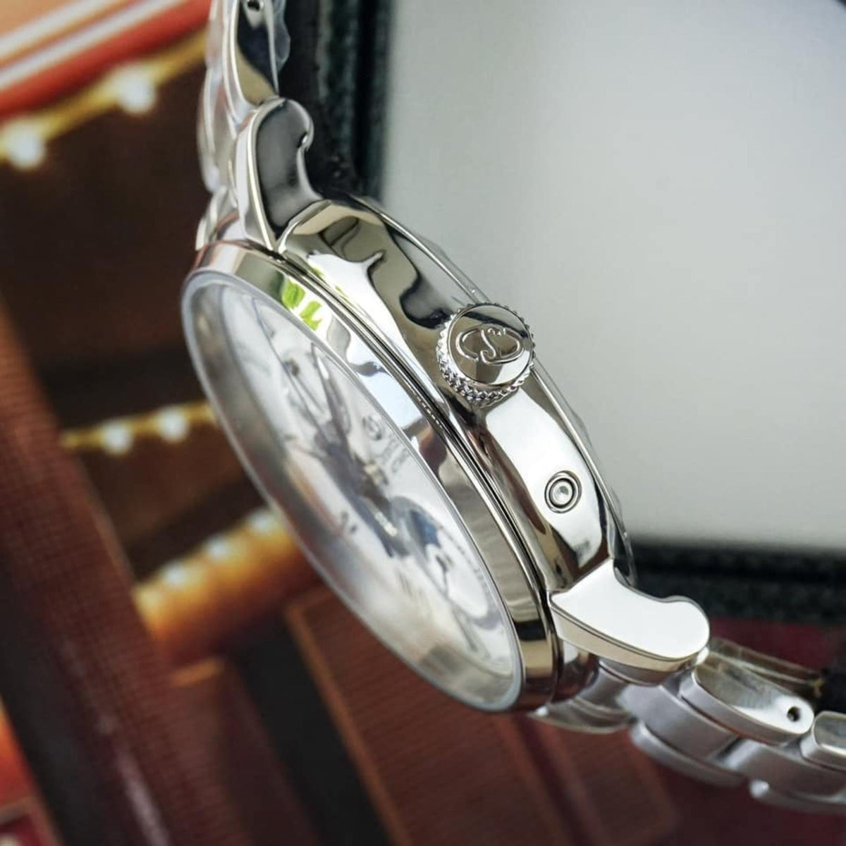 Stainless steel watch crown and polished case side with engraved logo