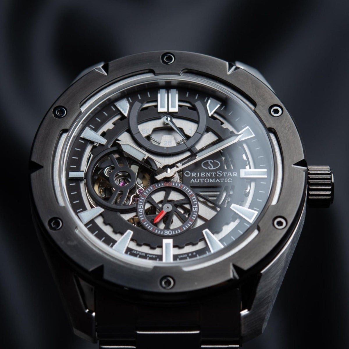 Men's automatic skeleton watch front view, black dial with exposed movements.