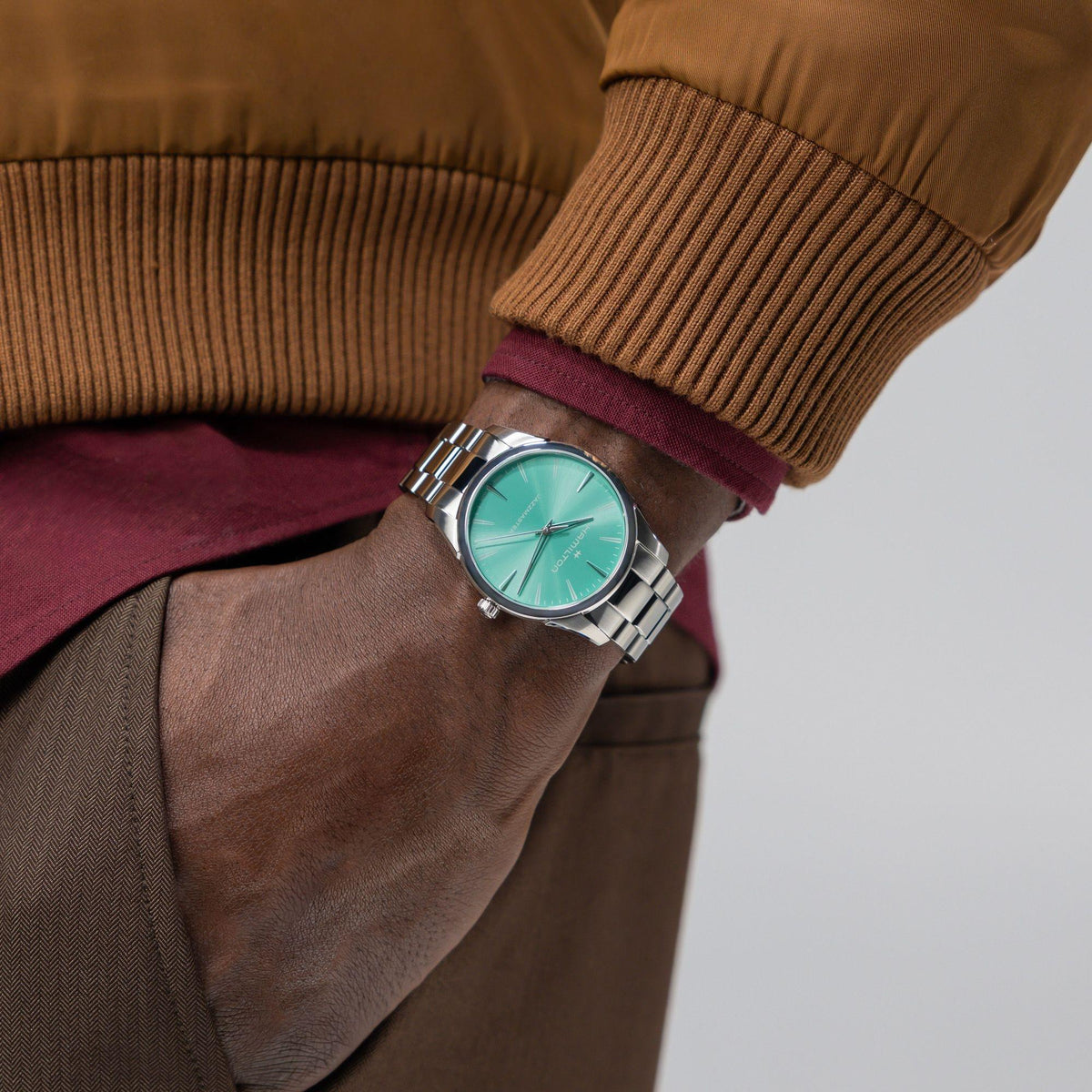 On-wrist lifestyle shot highlighting the Hamilton Jazzmaster H32461161 quartz watch styled with smart-casual attire