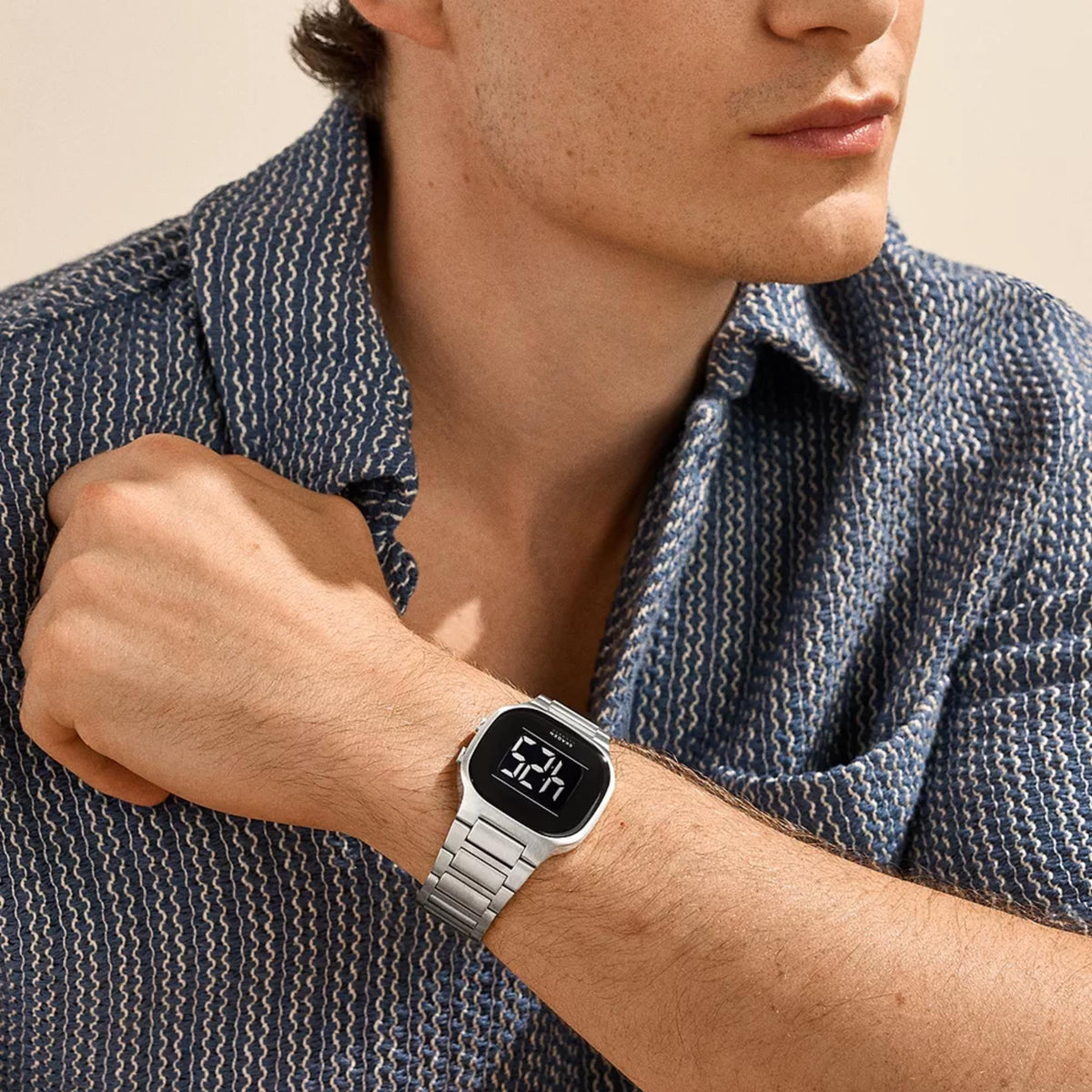 Skagen digital steel watch on arm with black digital display and silver bracelet