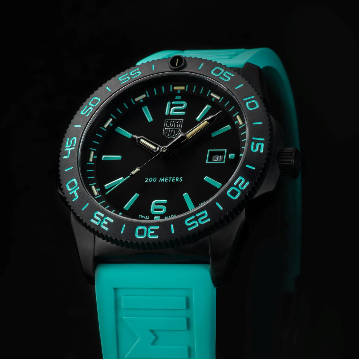Angled studio shot highlighting the dark stainless steel case, unidirectional bezel, and turquoise band of the Luminox Pacific Diver XS.3124.N.SET
