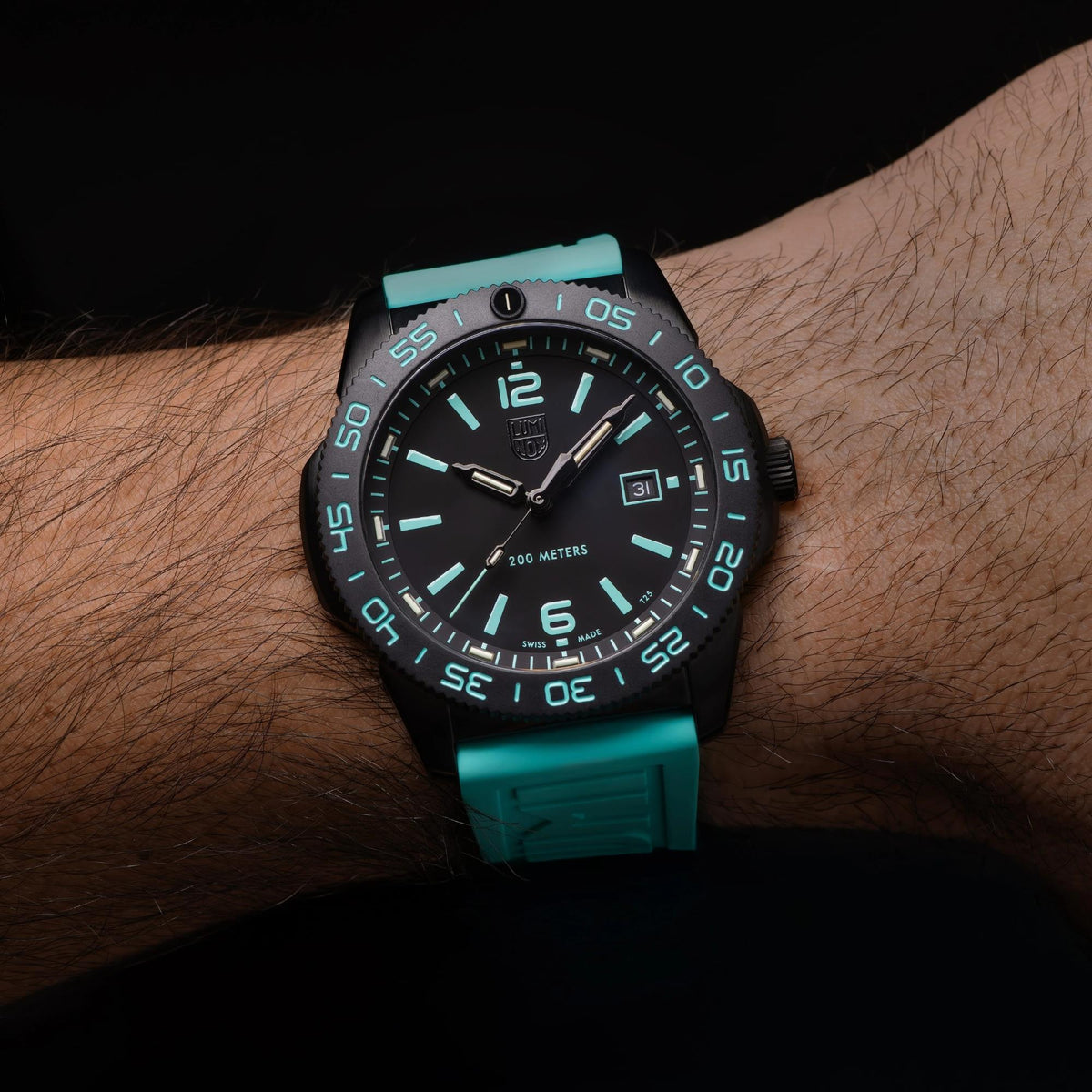 Close-up wrist shot of the Luminox Pacific Diver XS.3124.N.SET tactical timepiece with high-contrast turquoise accents