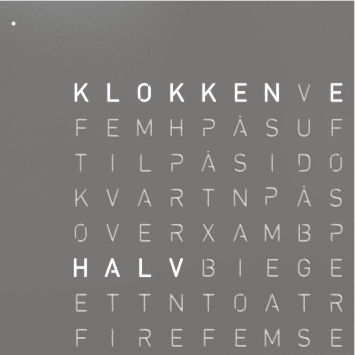 Close-up of grey QLOCKTWO Earth 45 word clock face with English letters visible
