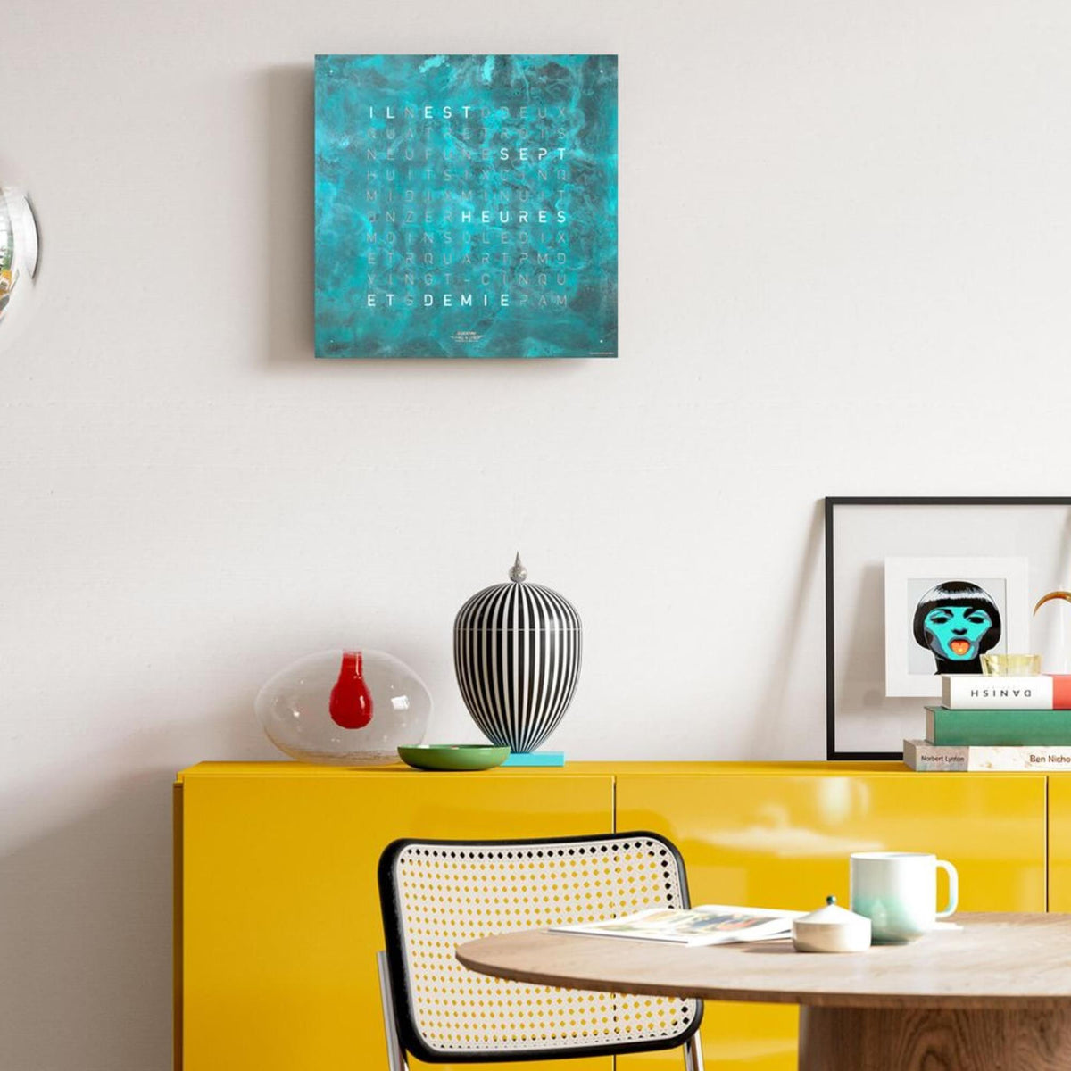 Square wall clock with teal textured face and engraved English word layout