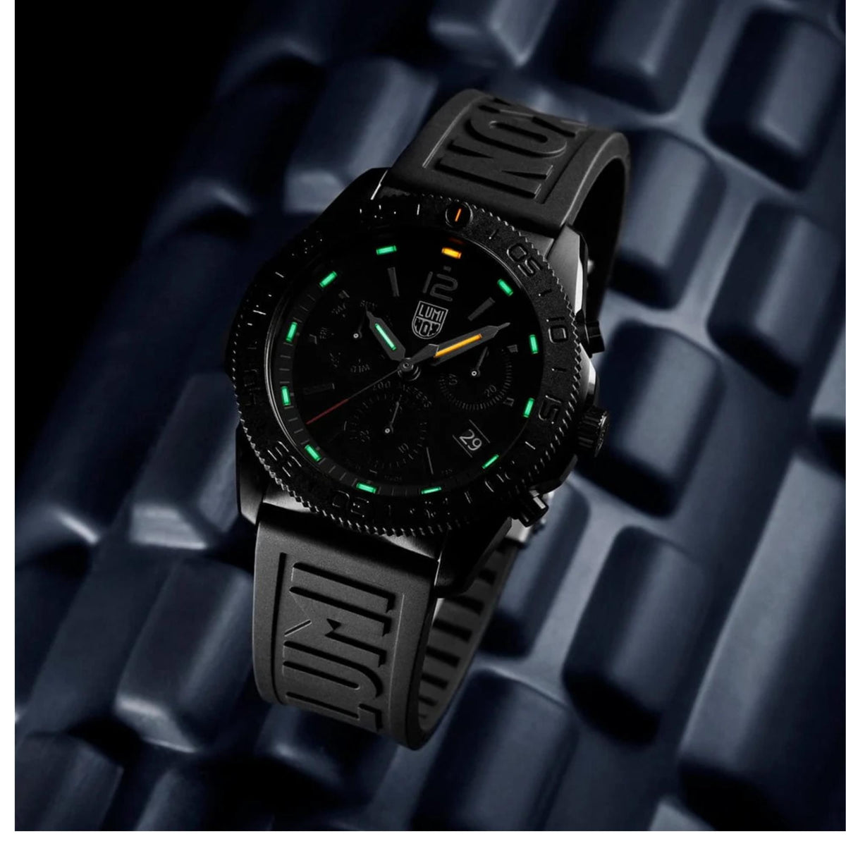Angled view of Luminox Pacific Diver XS.3141.BO.1 displaying illuminated hands and sub-dials in the dark