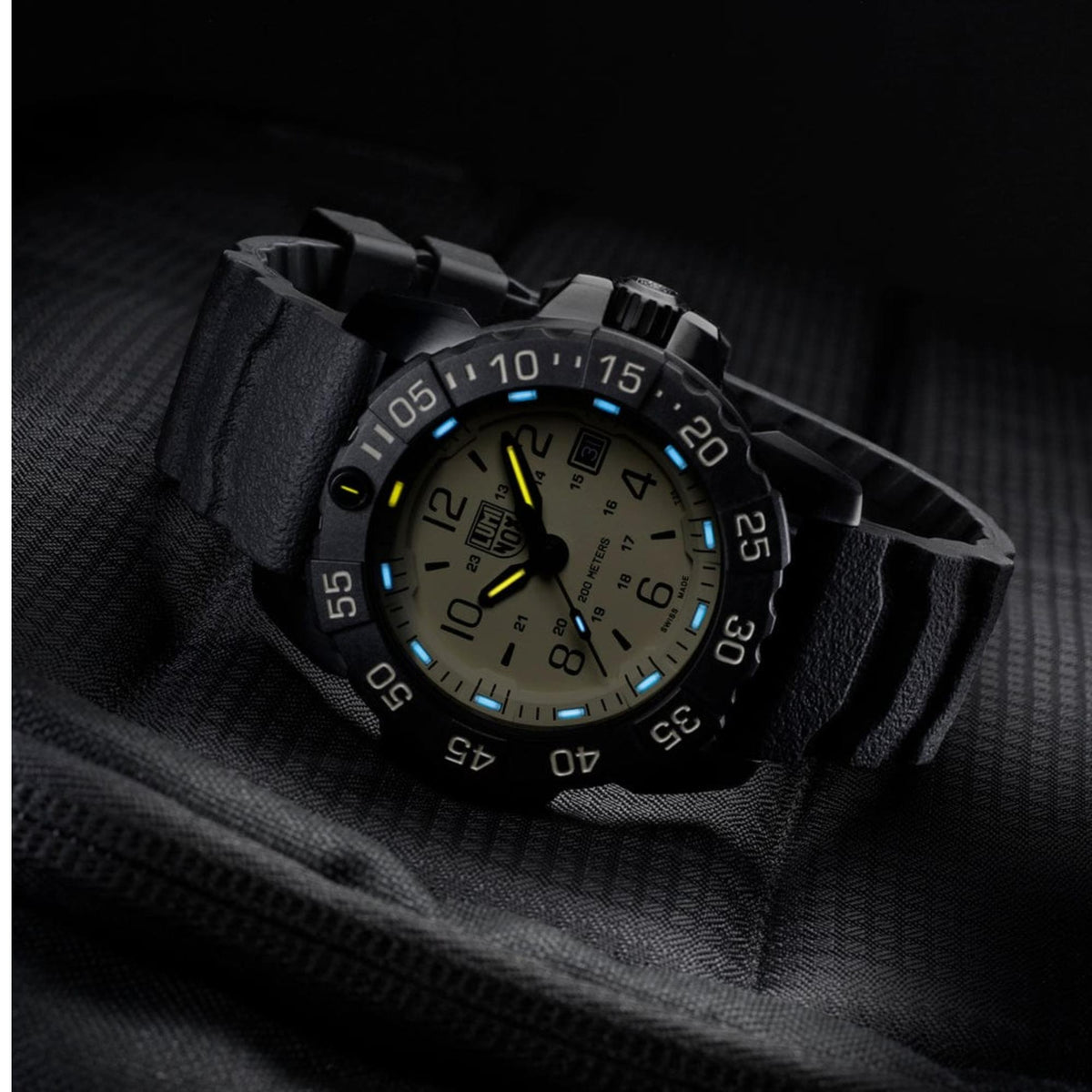 Luminox Navy SEAL Foundation XS.3251.CB.NSF.2 tactical quartz watch resting on dark fabric with glowing hands