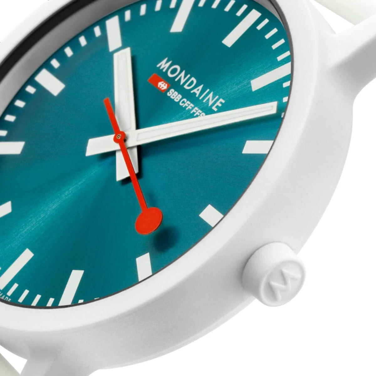 Teal dial quartz watch face with red second hand and white hour markers