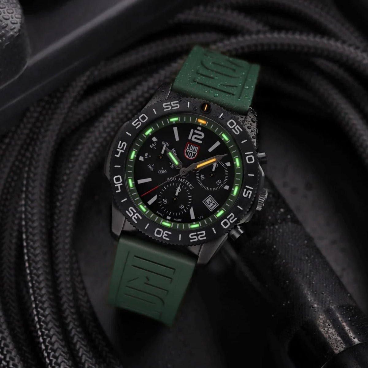 Men's diver chronograph watch with black dial, luminous markers, green rubber strap