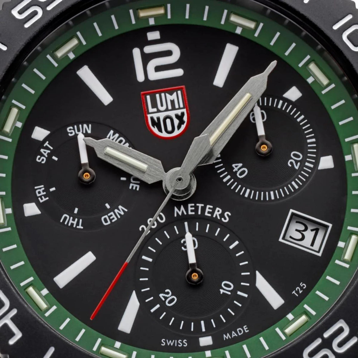 Men's diver chronograph watch dial close-up, black face with green ring and subdials