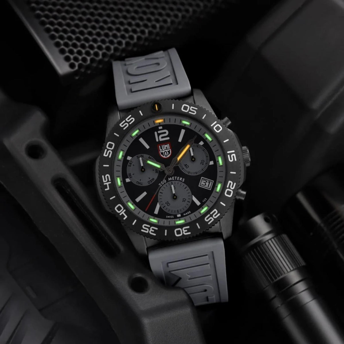 Luminox Pacific Diver chronograph watch three-quarter view with green glow, rubber strap