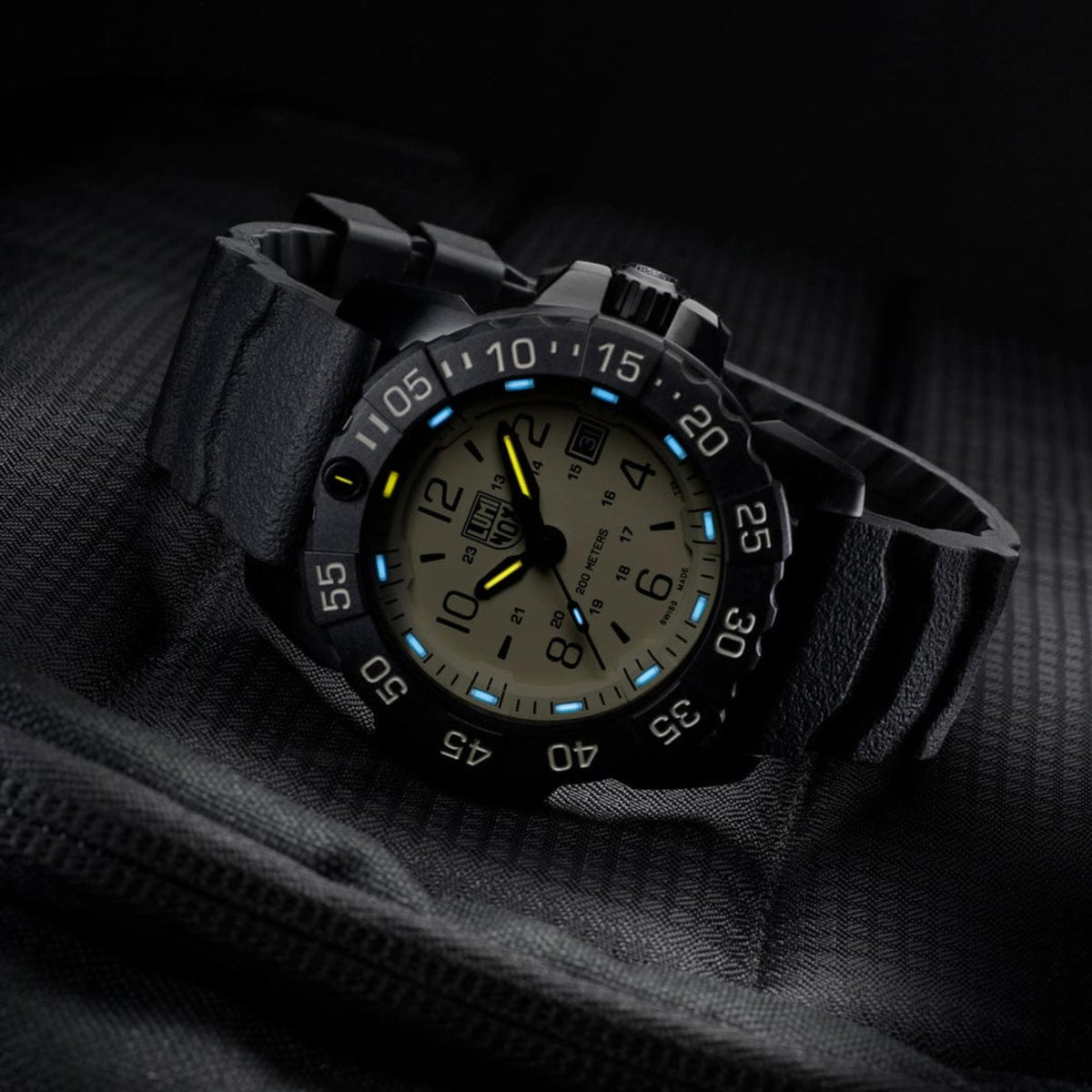 Mens quartz dive watch with sand dial and luminous markers, black rubber strap, angled view