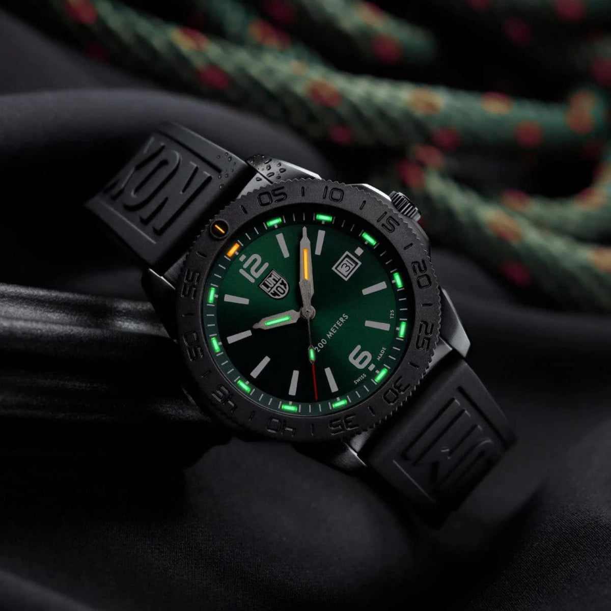 Luminox Light Technology self-powered illumination tubes glow green and orange on the Pacific Diver XS.3137.B dial
