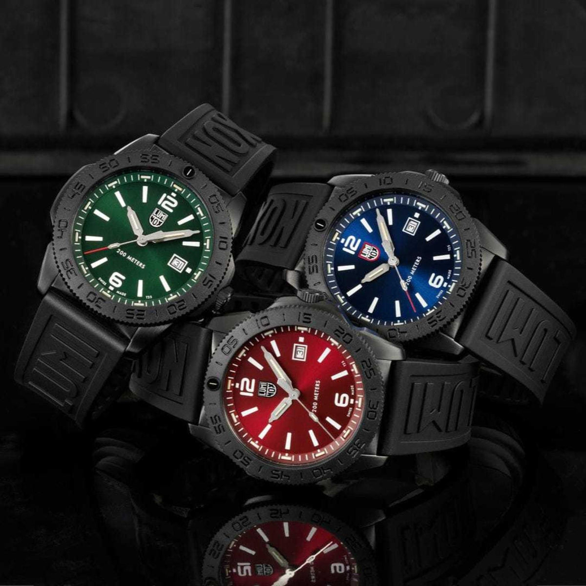 Luminox Pacific Diver 3120 series watches featuring green XS.3137.B, blue, and red dial models with black rubber straps