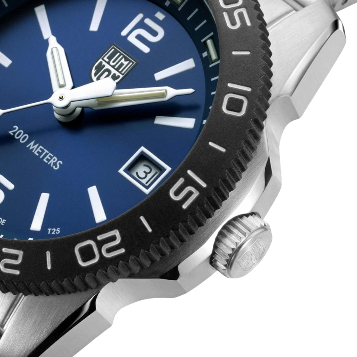 Close-up diver watch with blue dial, date window, and textured bezel detail