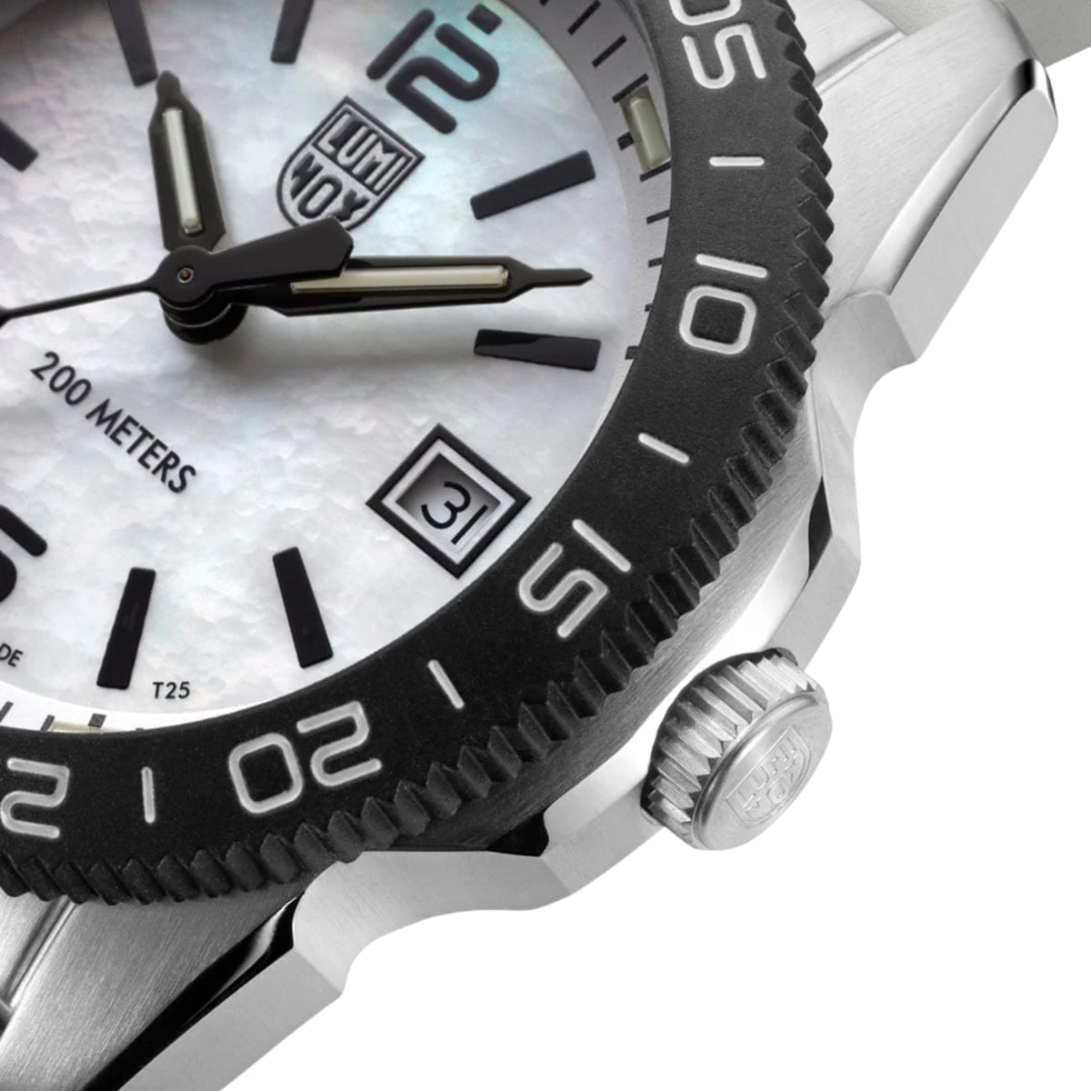 Close-up diver watch bezel and date window at 3 o'clock, stainless case