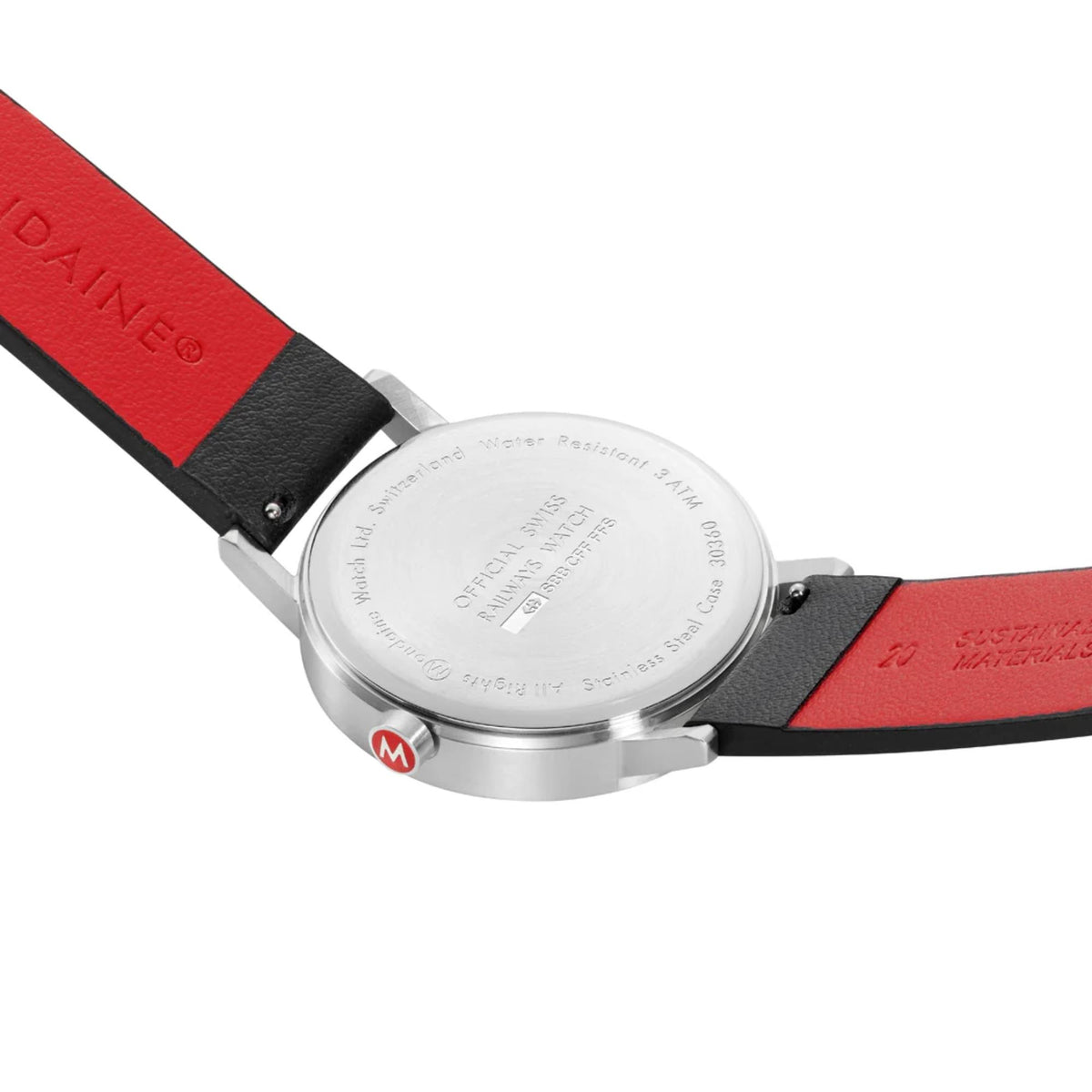 Stainless steel case back of Mondaine Classic A667.30360.11SBBV Swiss Railways watch, highlighting official SBB engravings and red sustainable leather strap undersides