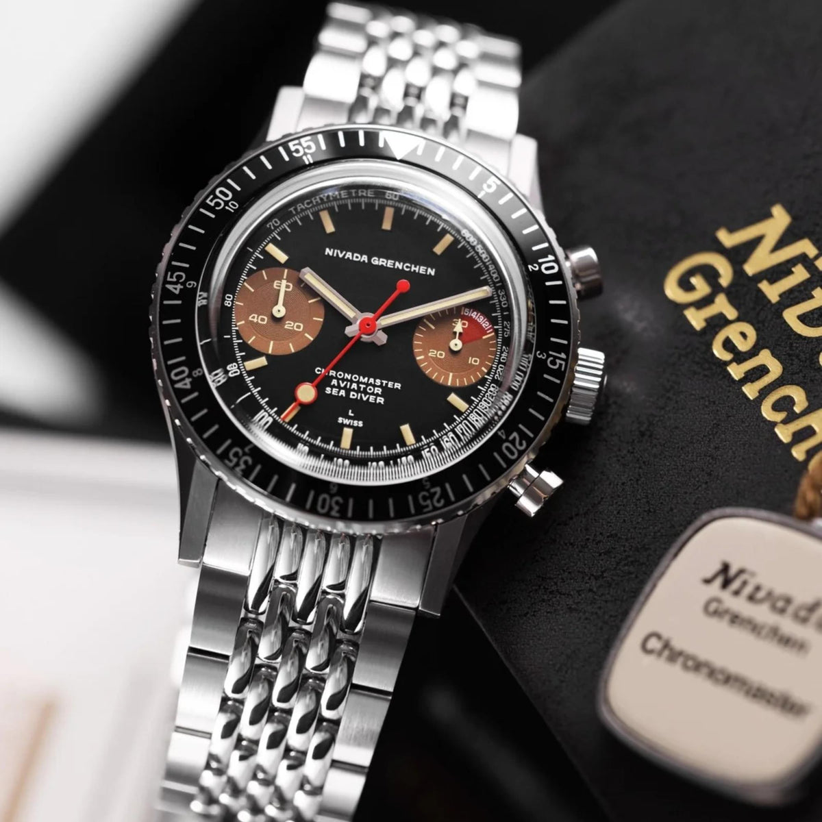 Nivada Grenchen Chronomaster 85008M04 angled front view resting on presentation box