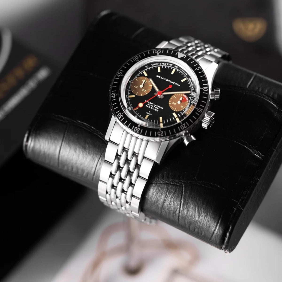 Nivada Grenchen Chronomaster 85008M04 angled view on black leather watch roll