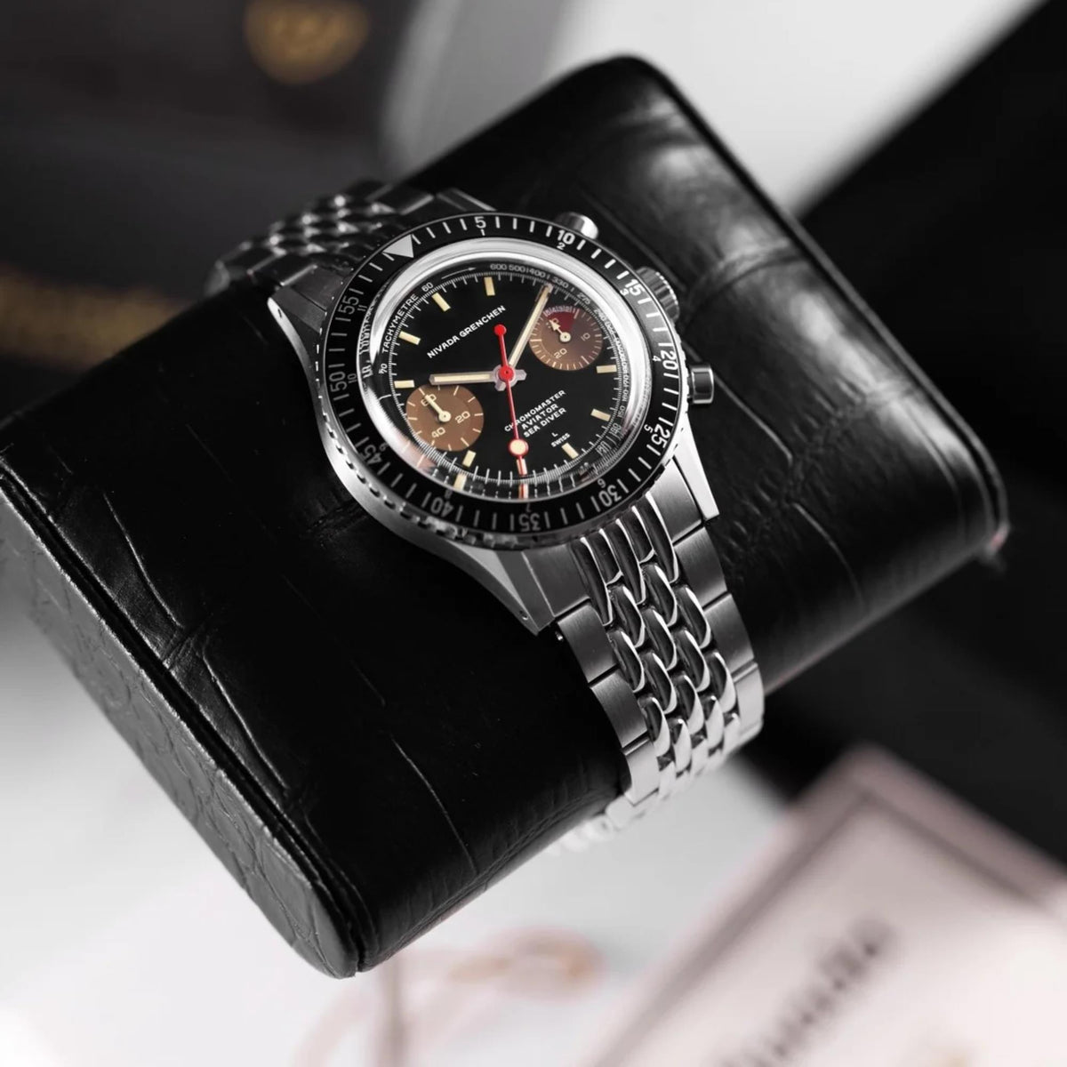 Nivada Grenchen Chronomaster 85008M04 alternate angle on black textured watch display