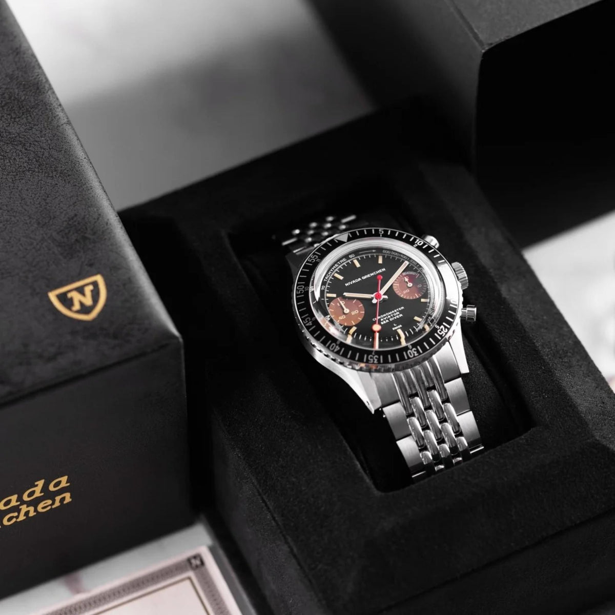Nivada Grenchen Chronomaster 85008M04 nestled inside black presentation watch box