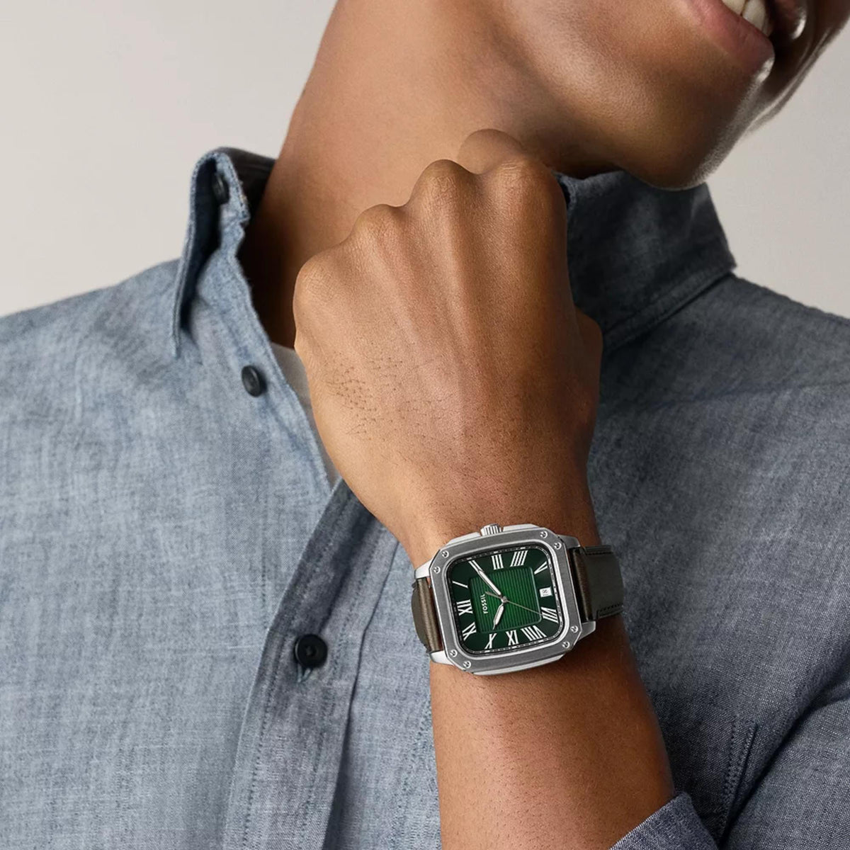 On-wrist view of the Fossil Crosby FS6150 quartz timepiece displaying a green dial, cushion-shaped steel case, and brown leather band