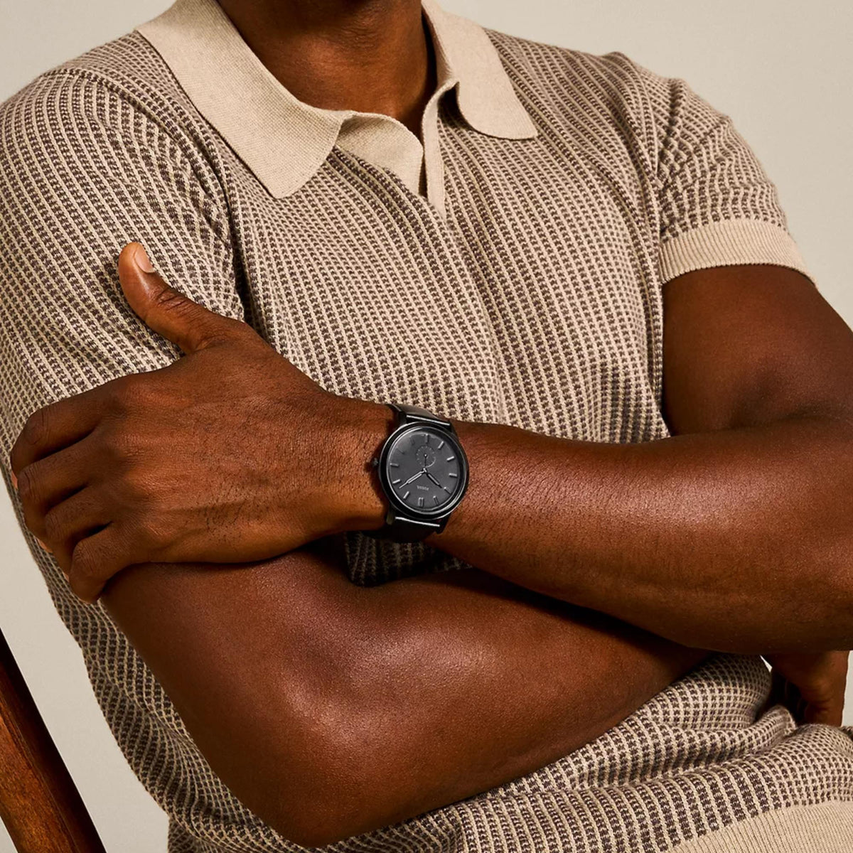 On-wrist shot of Fossil Minimalist FS5447 mens timepiece displaying the all-black design and black leather strap