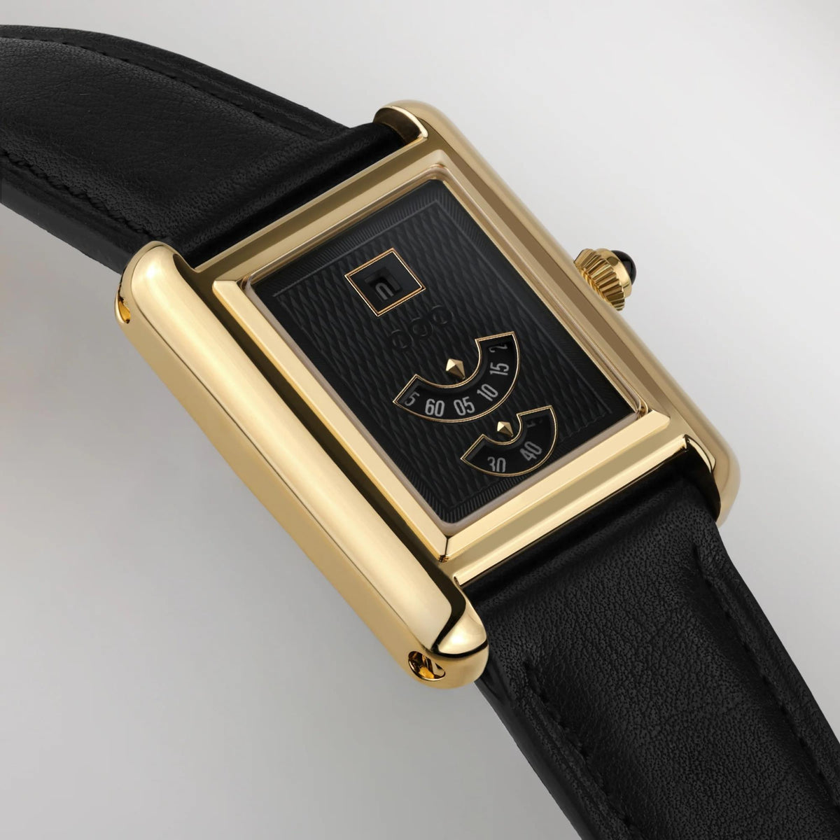 Automatic wristwatch close-up, gold-toned rectangular case, black dial, black leather strap