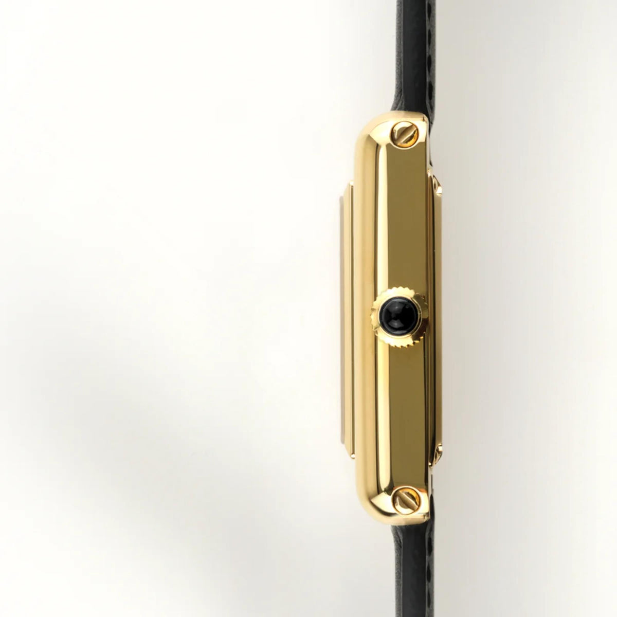 Automatic wristwatch side profile with gold case and crown; black leather strap
