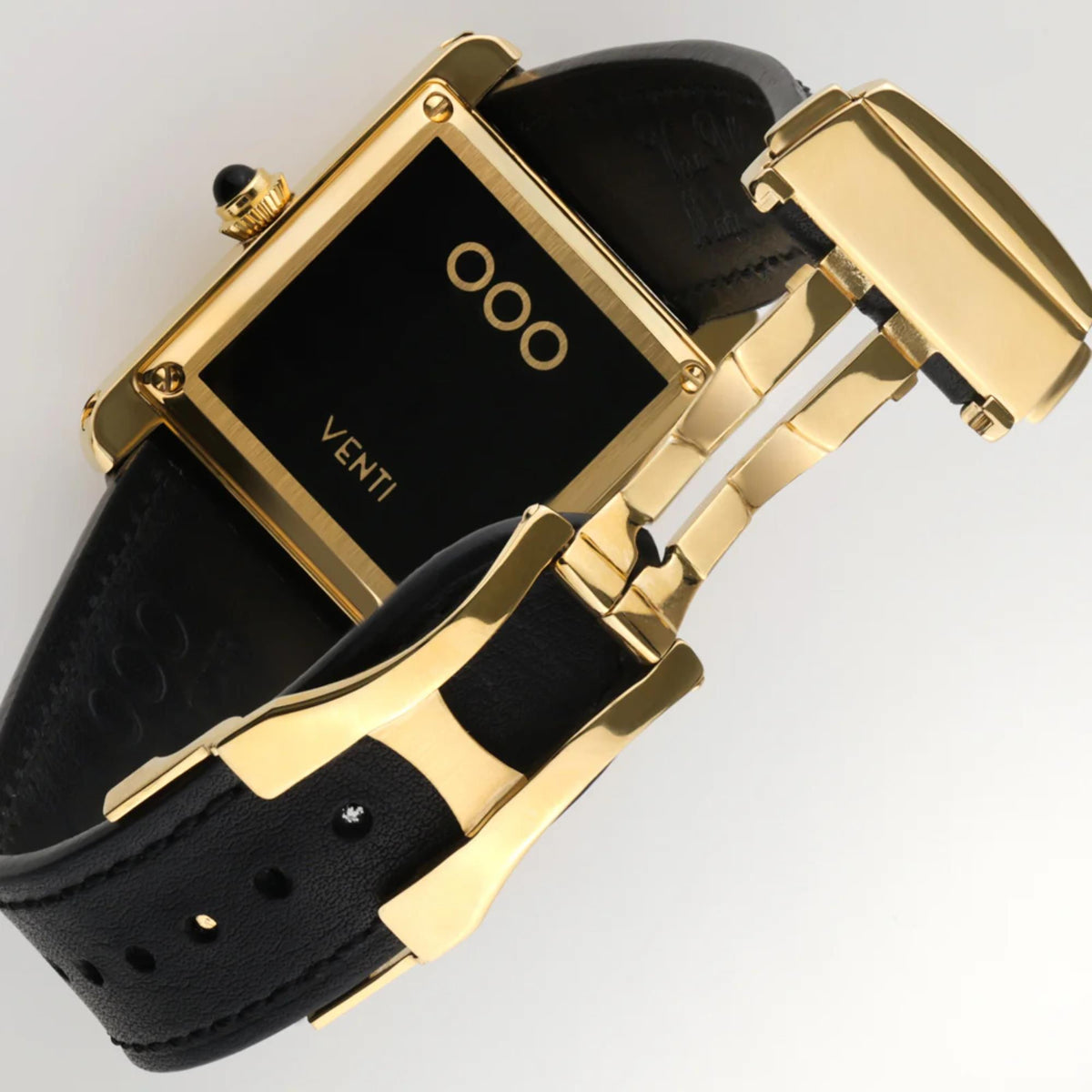 Automatic wristwatch with gold clasp and links on black leather strap
