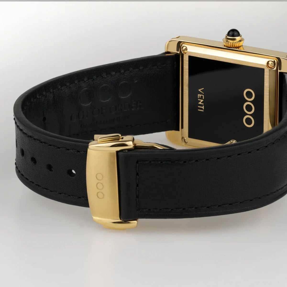 Automatic wristwatch with black leather strap and gold buckle clasp, black dial window
