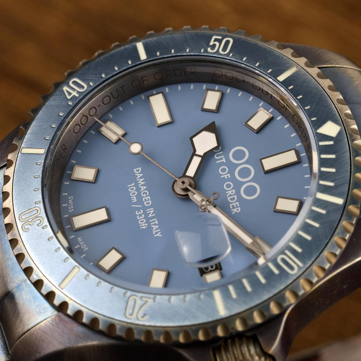 Men's quartz wristwatch blue dial with large hour markers, hands, and bezel numbers