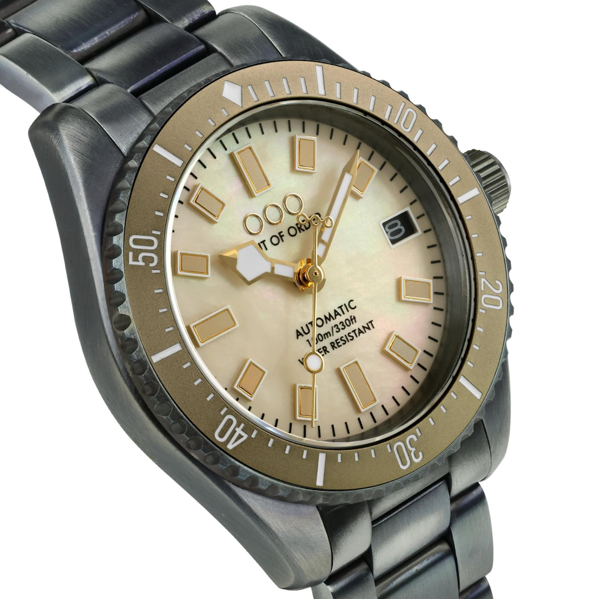Men's automatic wristwatch angled close-up of ivory dial with gold hands and markers
