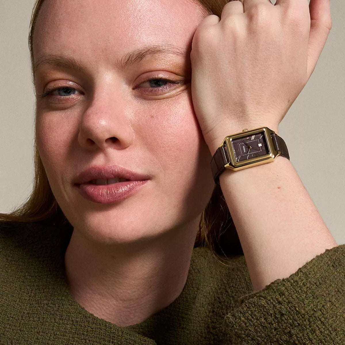 On-wrist view of Fossil Raquel ES5367 ladies timepiece showcasing the brown dial, gold-tone casing, and dark leather strap