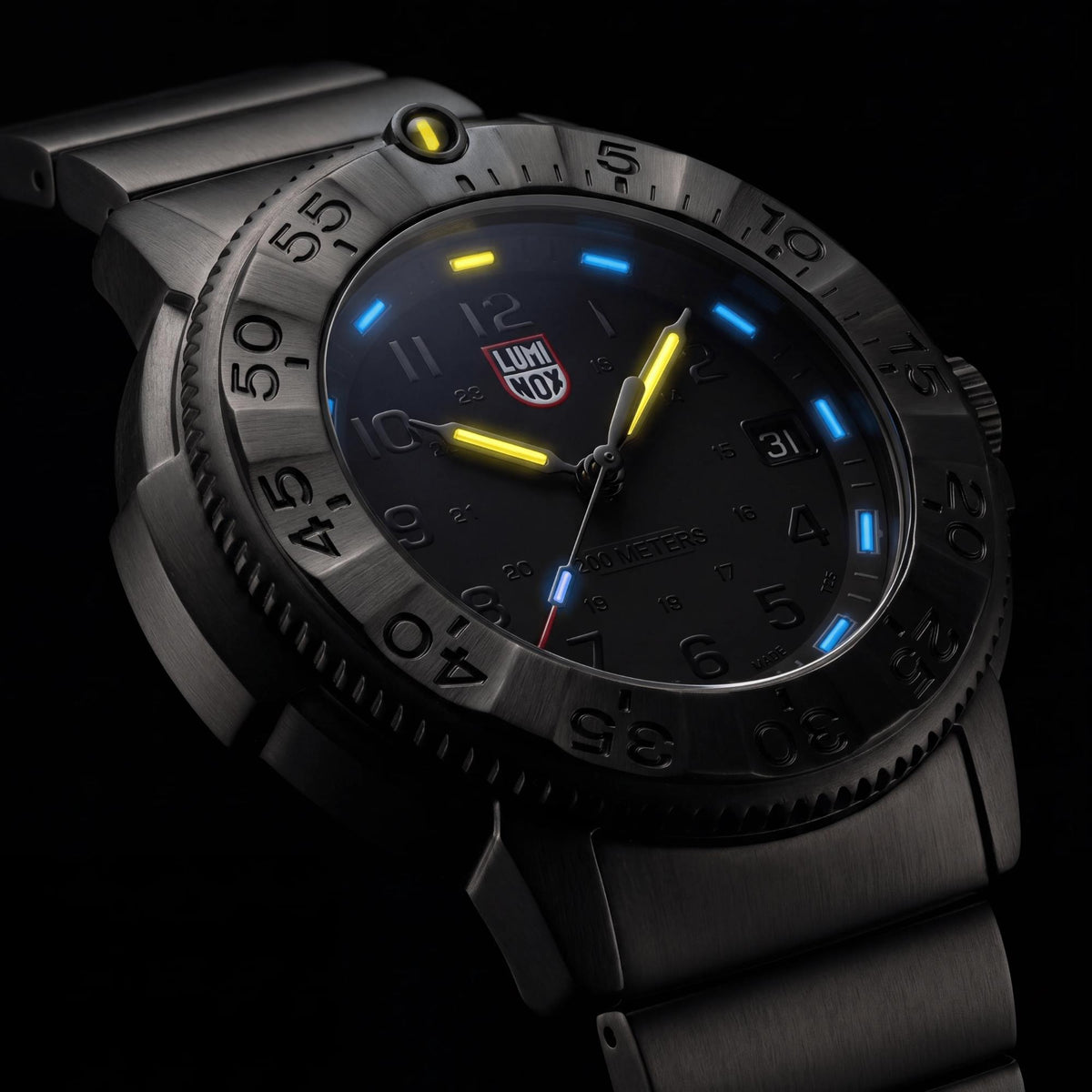 Nighttime view of yellow and blue glowing tritium hands and hour markers on Luminox Navy SEAL Foundation XS.3228.NSF