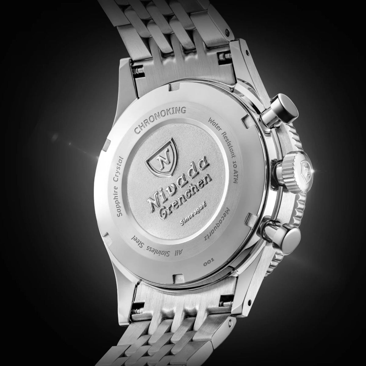 Close-up of stainless steel caseback of the Nivada Grenchen Chronoking watch, featuring engraved branding text and technical specifications