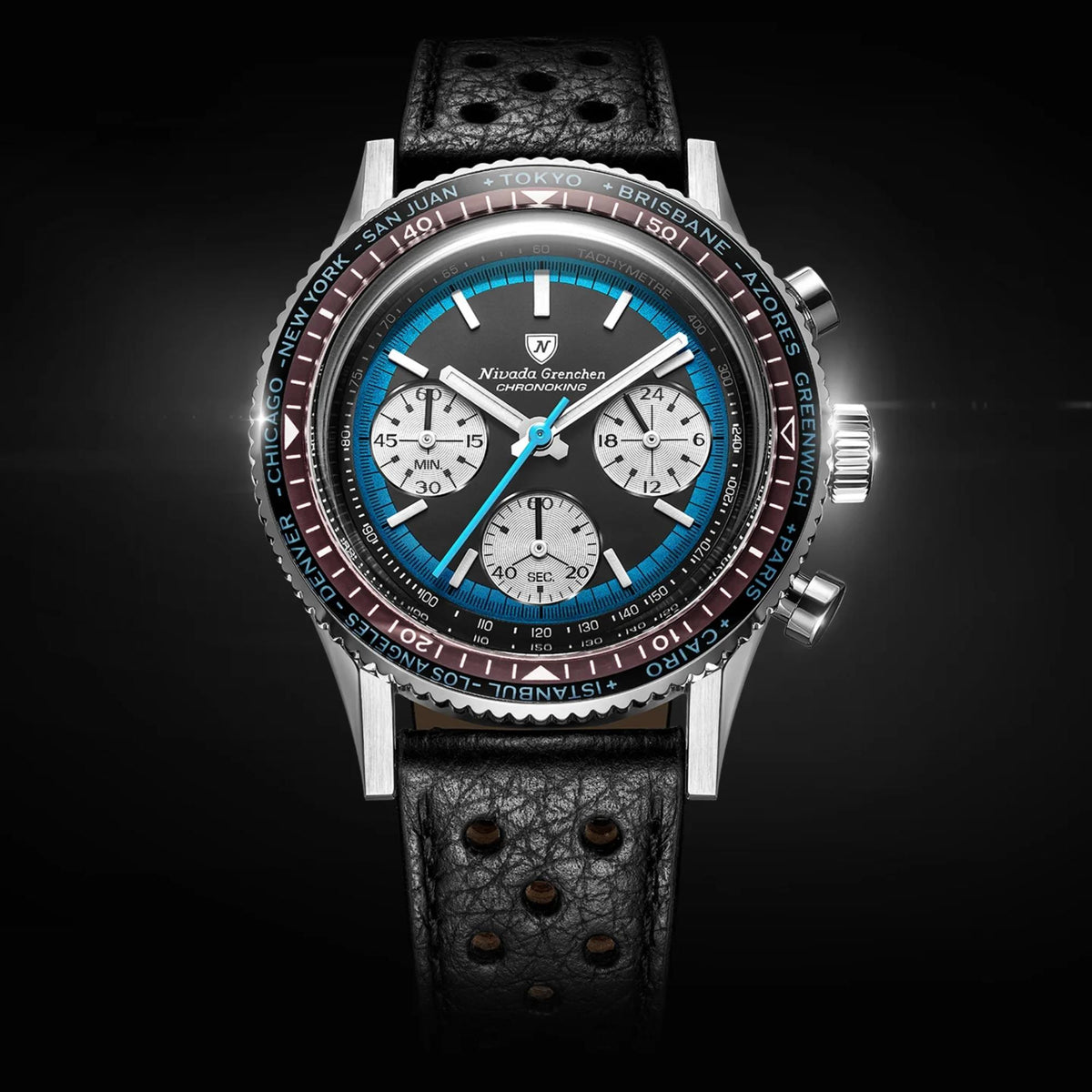 Nivada Grenchen Chronoking 38mm Chronograph with a stainless steel case, black leather strap, and a blue dial with white subdials and a dark red tachymeter bezel, shown against a dark background