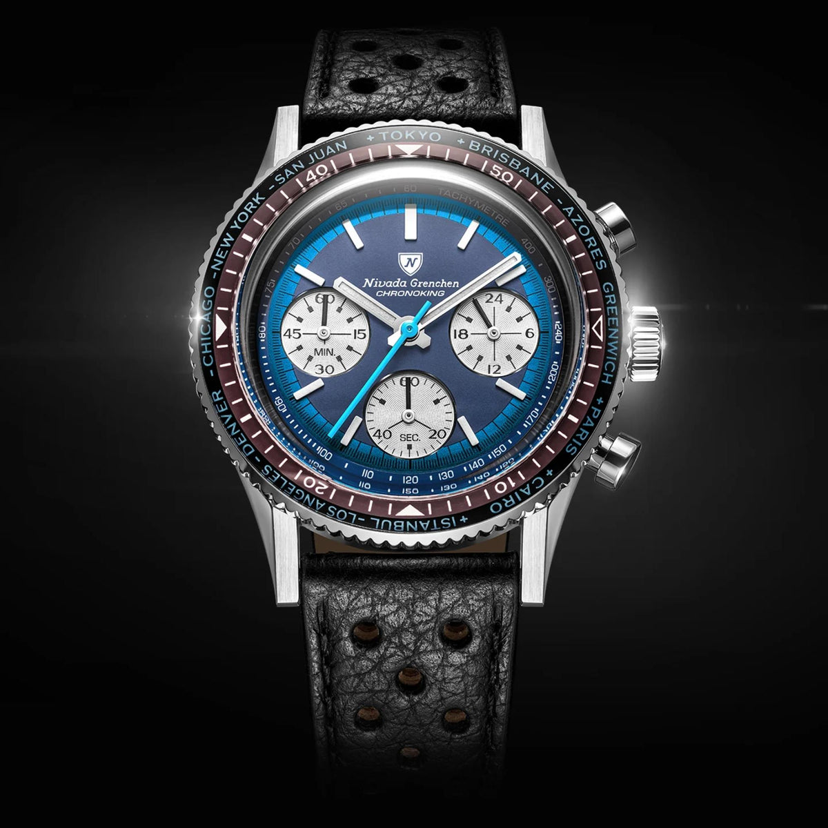 Nivada Grenchen Chronoking watch with a stainless steel case, a blue dial with three white subdials, a black textured leather strap, and a black and red rotating bezel, shown against a dark background