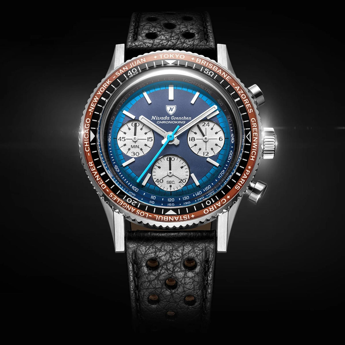 Nivada Grenchen Chronoking watch with a stainless steel case, a leather strap, a 38mm blue dial, and a copper-colored tachymeter bezel, shown against a dark background