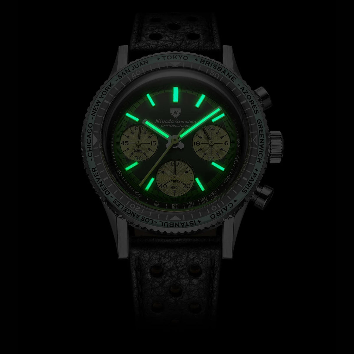 Close-up shot showcasing the bright green luminous watch hands and hour markers glow-in-the-dark feature on the Nivada Grenchen Chronoking
