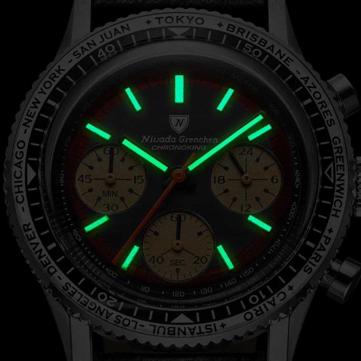 Close-up shot showcasing the bright green luminous watch hands and hour markers glow-in-the-dark feature of the Nivada Grenchen Chronoking dial