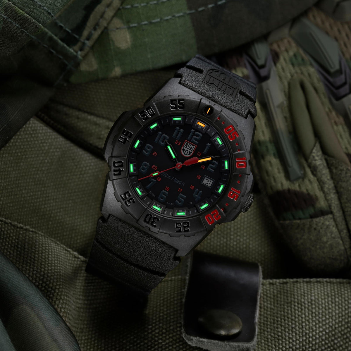 Luminox Navy SEAL 3550 Series XS.3565 low-light view showing luminous dial display resting on military gear