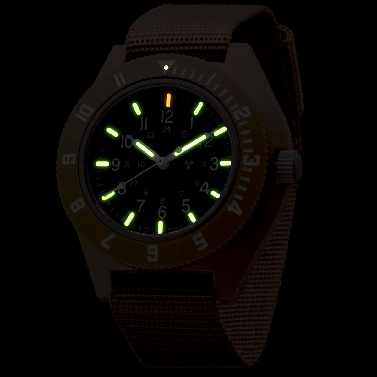 Marathon Navigator WW194001DT-0802 mens analogue watch showing glowing tritium gas tubes on black dial in low light